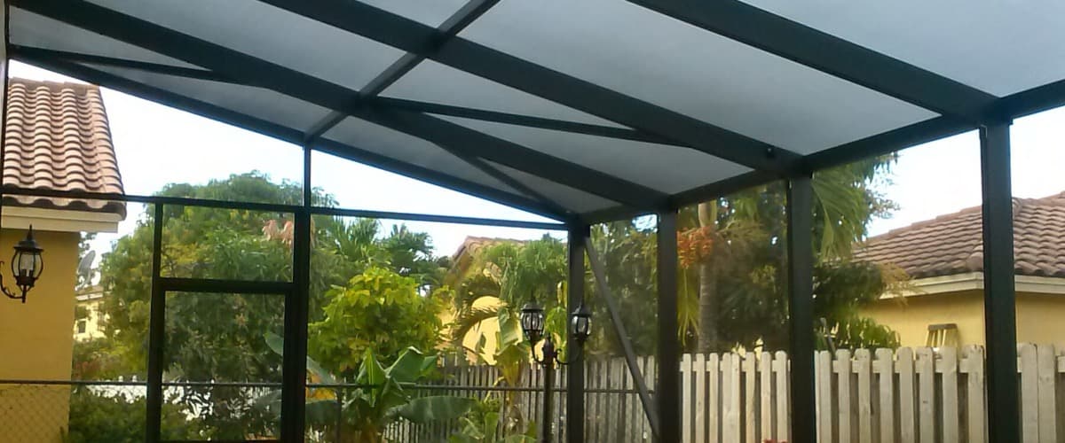 Professional pool enclosure with aluminum fascia installation in South Florida